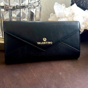 Black and gold leather wallet by Mario Valentino.